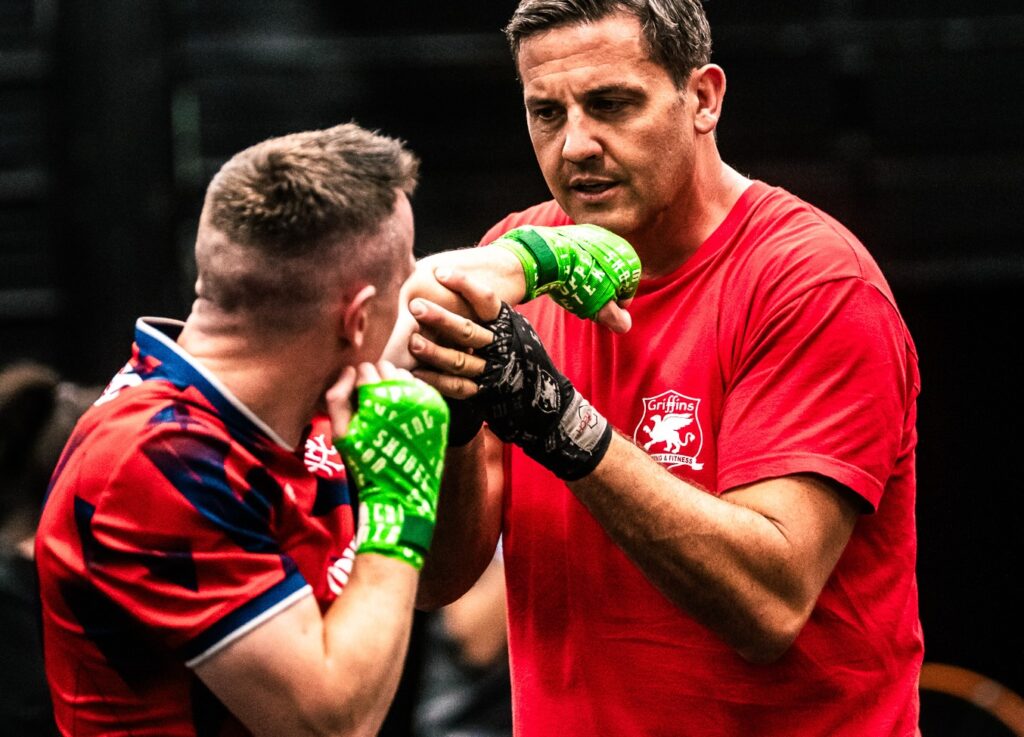 Dave of Griffins Boxing helping a student with his form.