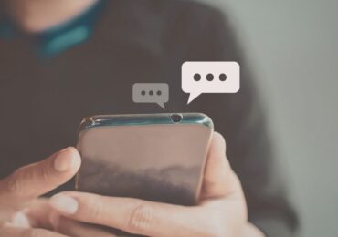 Someone using an AI chatbot on their phone, to connect to their wellness center.