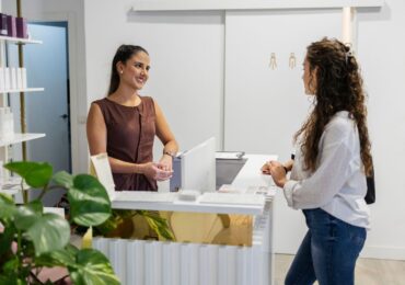 A wellness business owner welcomes a client with her new all-in-one business software.