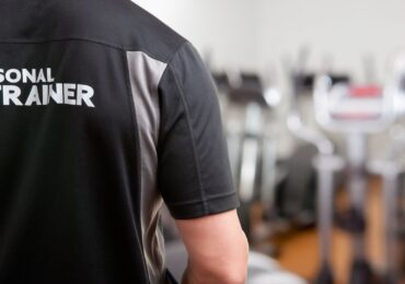 A personal trainer who hasn't chosen a name for his business yet wears a generic uniform at work.