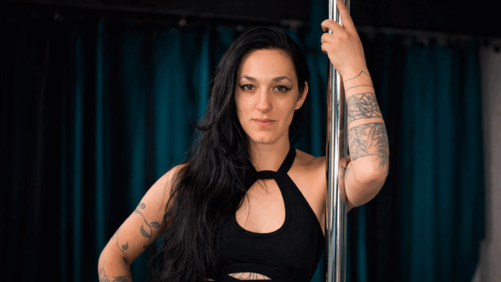 Jackie Sobel, owner of Fitness Envi Pole Studio, stands beside a pole