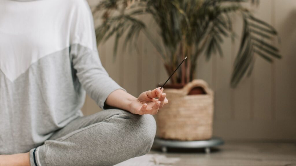 A wellness studio owner meditating in her studio run by WellnessLiving.