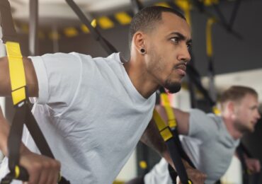 Two men competing in the CrossFit Games at their favorite gym.