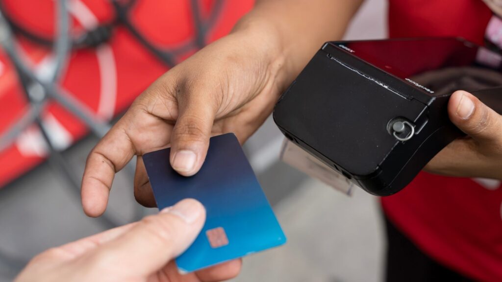 A client paying for their membership with a handheld device.