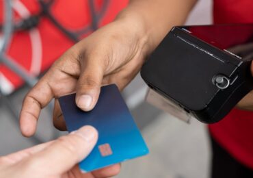 A client paying for their membership with a handheld device.