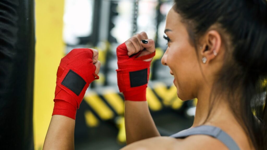 The owner of a kickboxing studio, warming up before a class.