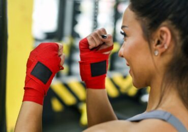 The owner of a kickboxing studio, warming up before a class.