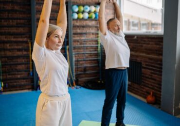 Two people in a stretching class at Achieve Therapy and Fitness.