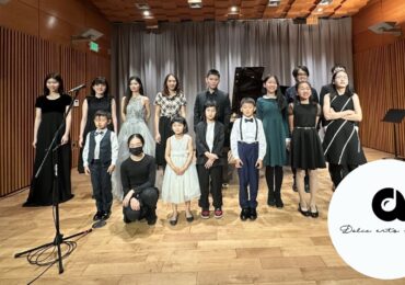 A group of music students at Dolce Arts Studio taking a group shot before a performance.