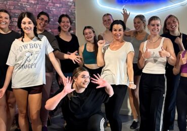 A group of dancers at Drop In Dance Winnipeg, posing for a photo.