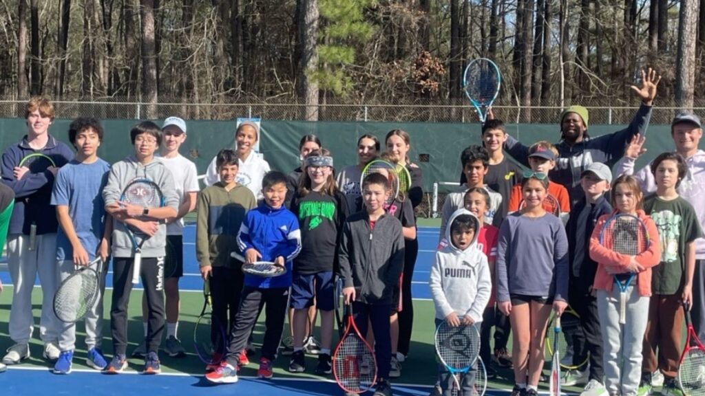 A group of happy kids after their tennis camp with Empact sport coaching.