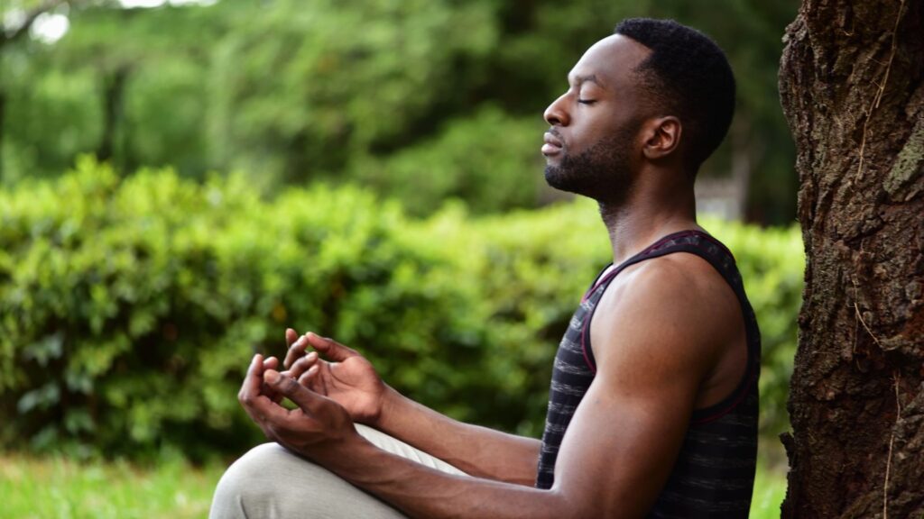 A young man meditating at Live Well Holistic Health Center.