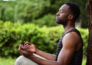 A young man meditating at Live Well Holistic Health Center.