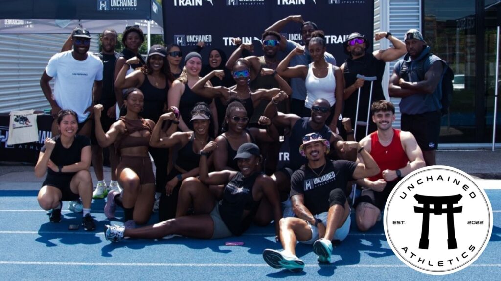 A group of fitness buffs from Unchained Athletics taking a group shot at a tournament.