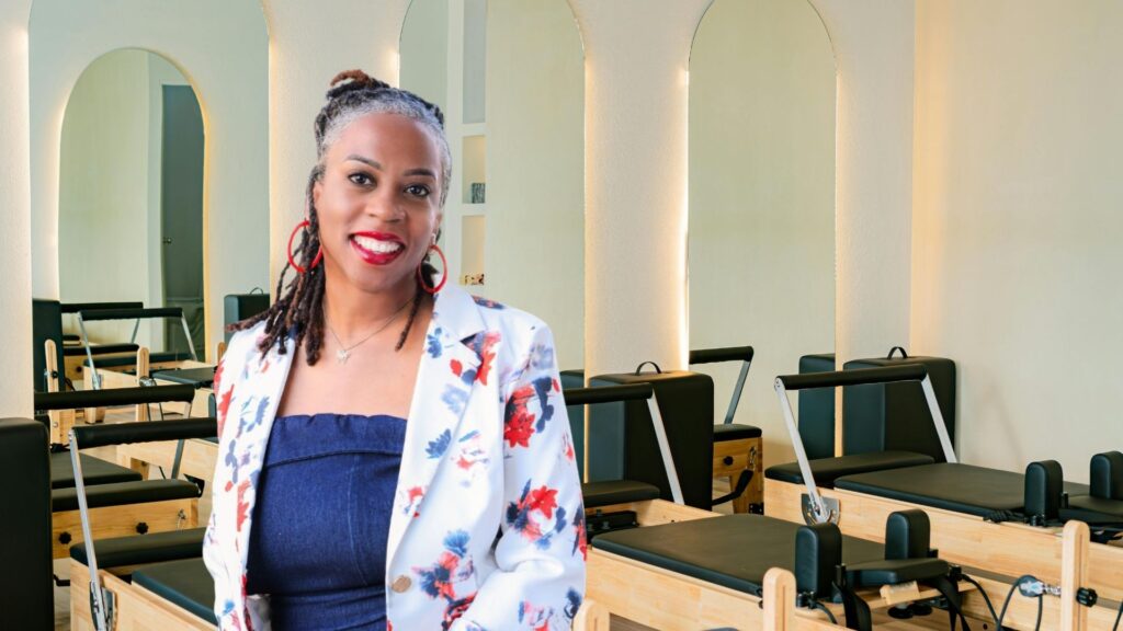 The owner of Pilates 4 Me, posing in front of her equipment.