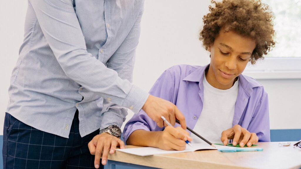 A student learning with his tutor at Squarepeg Learning.