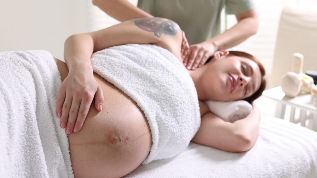 A pregnant person getting a massage from the Des Moines Prenatal Massage clinic.