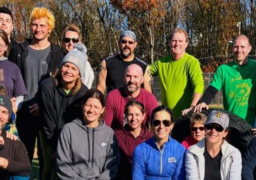 A group of trainees in an outdoor group photo with Evolution Fitness Now.