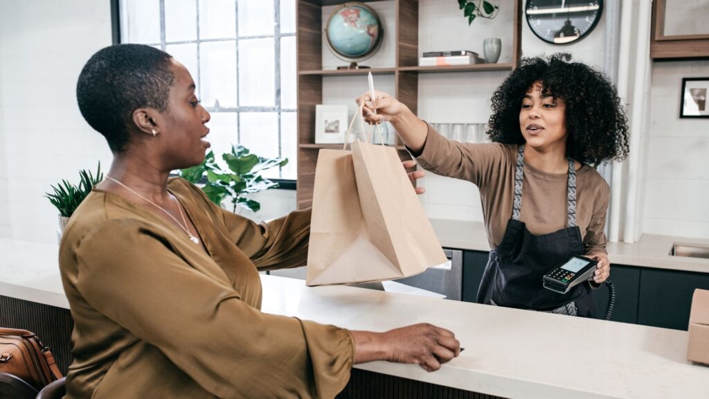 A repeat customer at a wellness salon, purchasing something with her rewards points.