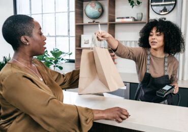 A repeat customer at a wellness salon, purchasing something with her rewards points.