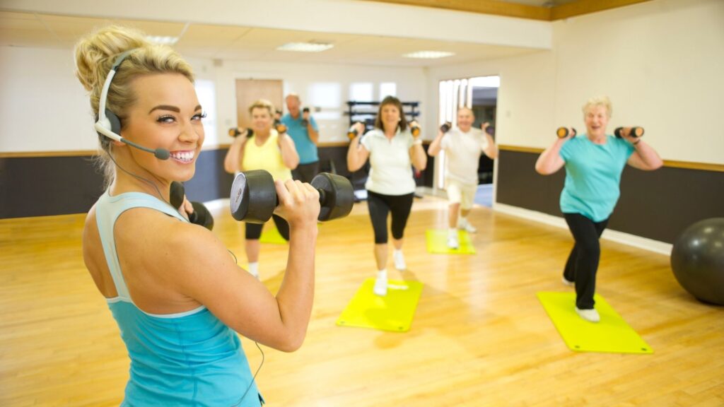 A celebrity fitness instructor, leading a small private class.
