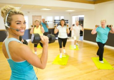 A celebrity fitness instructor, leading a small private class.