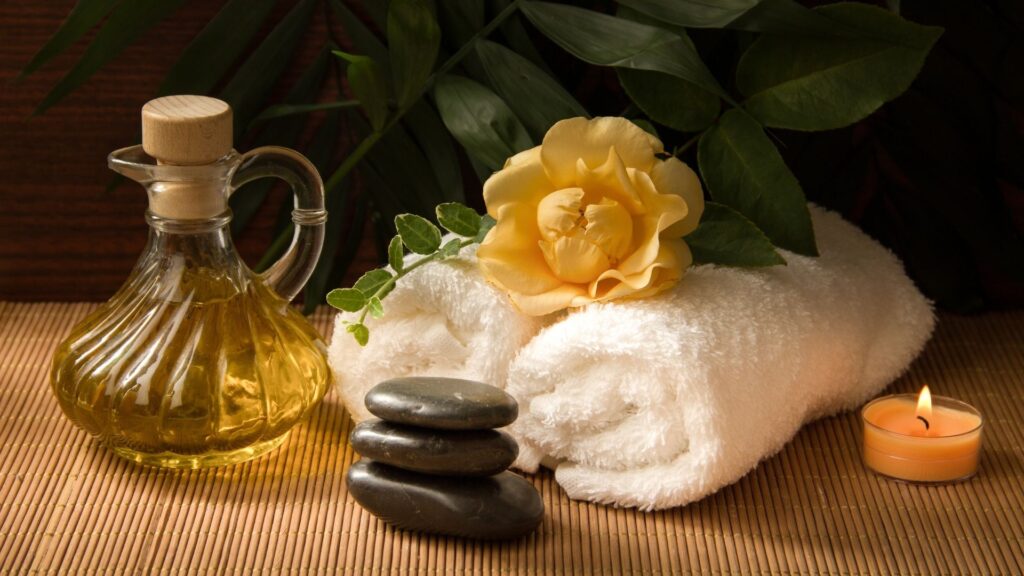 A beautiful arrangement of towels, oils, candles, and other spa necessities at Elemental Life Spa.