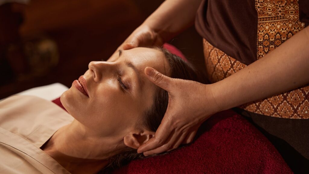 A spa client relaxing during a massage booked with WellnessLiving.