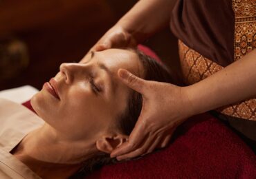 A spa client relaxing during a massage booked with WellnessLiving.