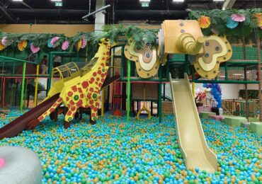 A colorful play cafe with a jungle theme, run with WellnessLiving's custom software.