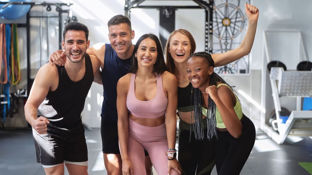 A small gym class, excited to get a free training session from their loyalty program.
