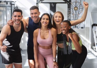 A small gym class, excited to get a free training session from their loyalty program.