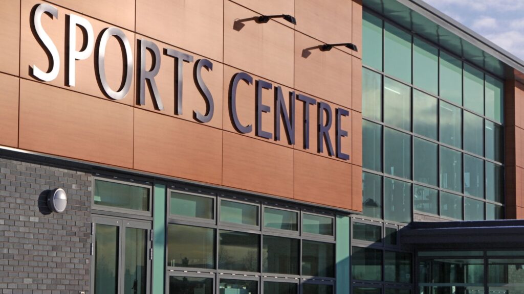 The front doors of a sports center run by WellnessLiving's 24-hour gym door access software and app.