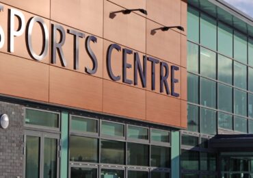 The front doors of a sports center run by WellnessLiving's 24-hour gym door access software and app.