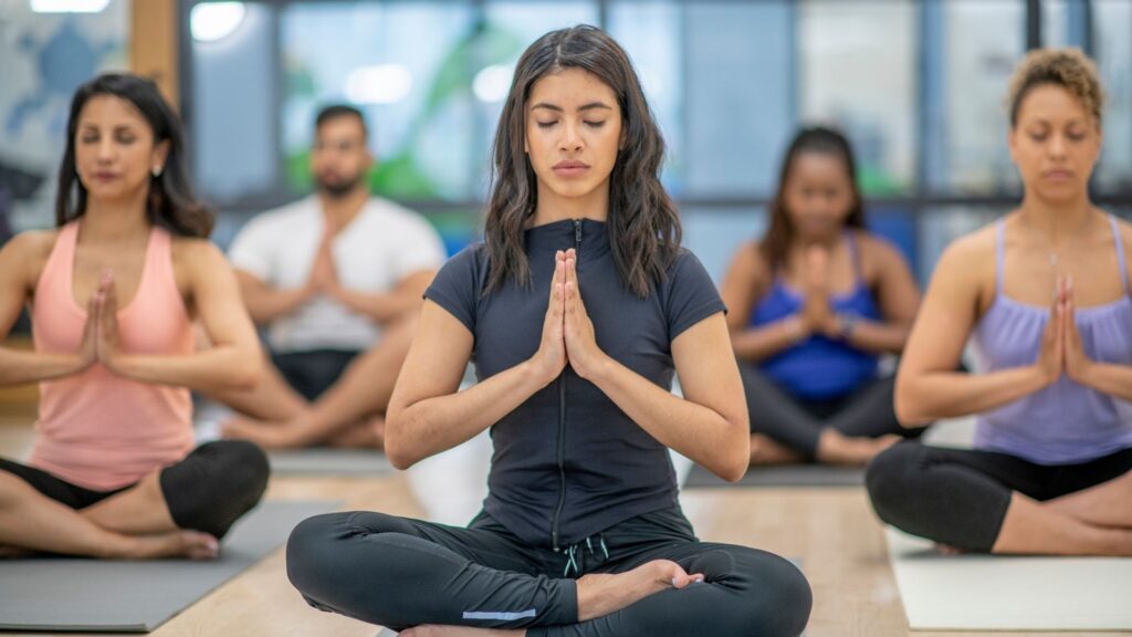 A corporate yoga class, taking place on the company's lunch break.