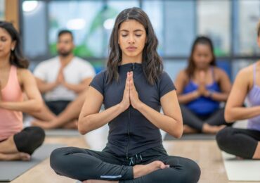 A corporate yoga class, taking place on the company's lunch break.