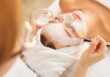 A woman getting a facial at a spa run by WellnessLiving.