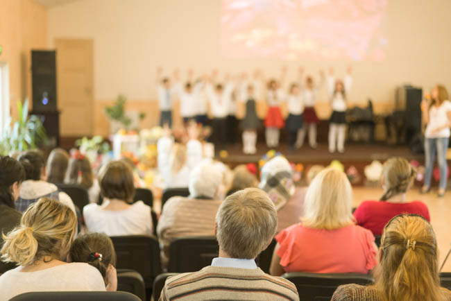 Planning Music Recitals, parents watch children's recital 