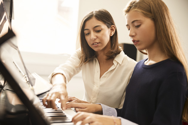 Music School Promotion, student being taught by teacher