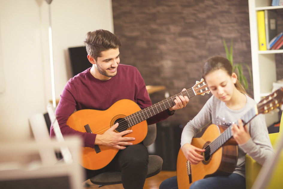 Music Instructors, music instructor teaching the guitar to his student
