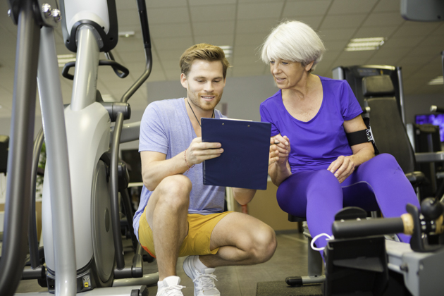 gym staff, trainer with mature client