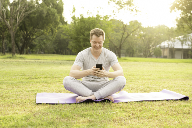 yoga classes for men, man on phone