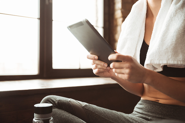 start a yoga studio, yogi holding tablet